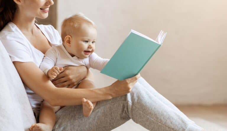 Mom reading book with baby on her lap