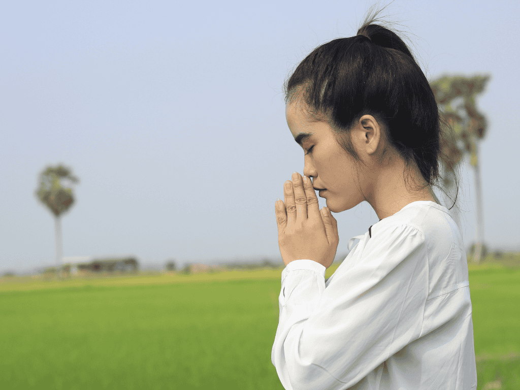 Does God really exist
Young woman with head bowed and hands folded in meditation, symbolizing deep reflection on faith, prayer, and the question “Does God really exist?” Represents belief, hope, and the search for biblical and logical proof of God’s existence.
