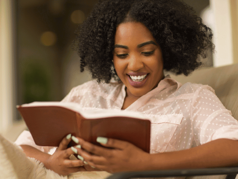 How to Study the Bible A woman studying the Bible on her own while sitting on a cozy couch, representing how moms can create a simple and meaningful home Bible study routine. This inspiring image highlights personal devotion, quiet time, and practical tips for how to study the Bible for moms seeking growth in faith.